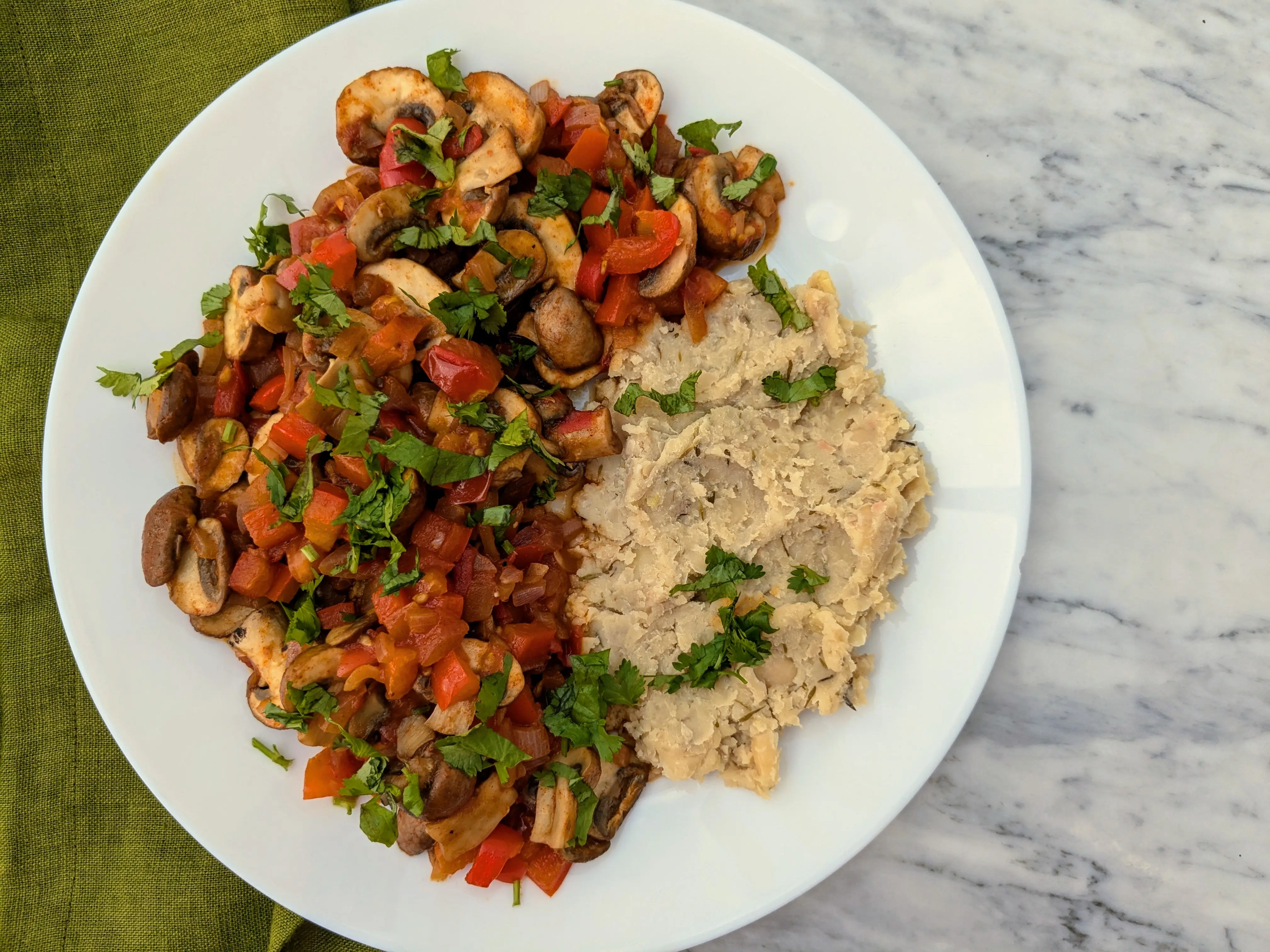 Vegan mushroom and tomato stew with butter beans mash