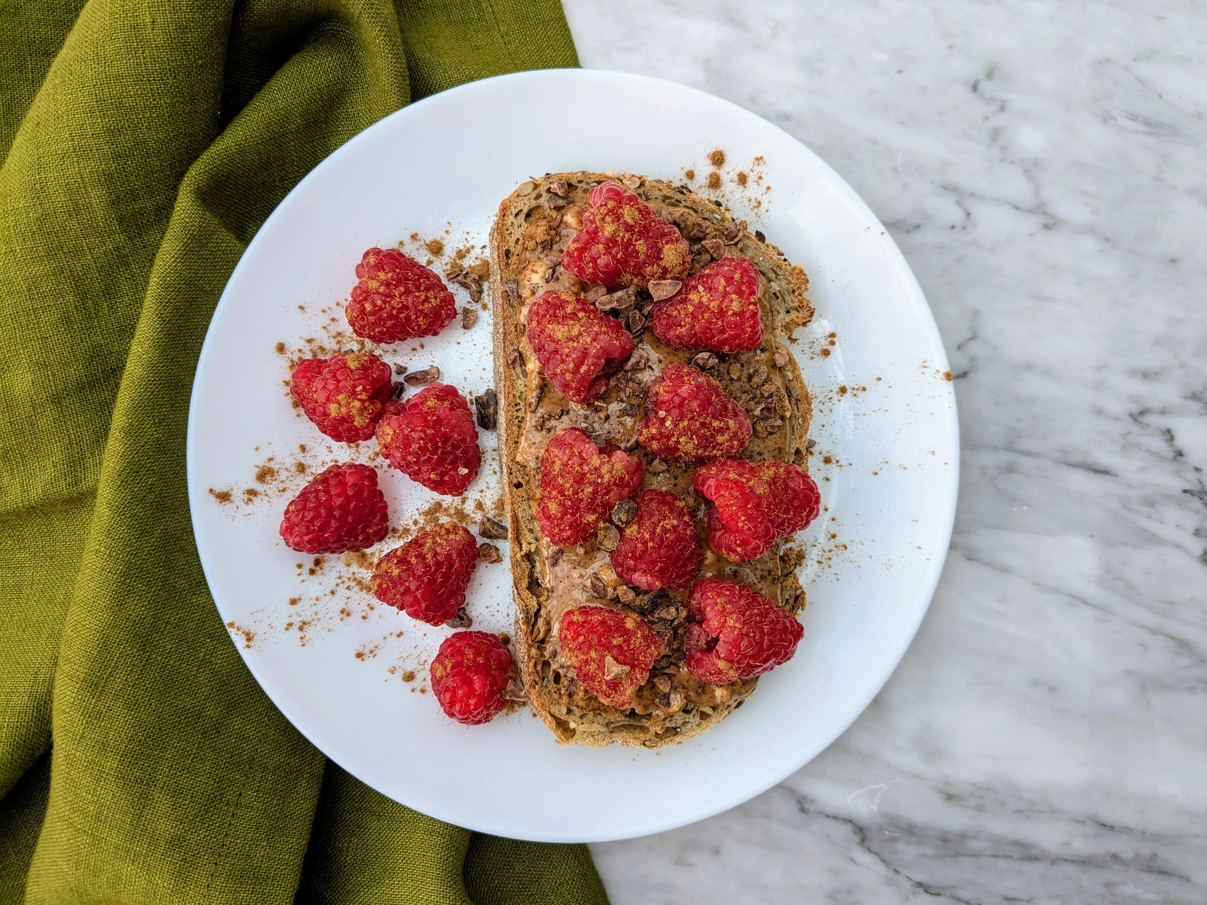 Vegan raspberries and almond butter on sourdough toast
