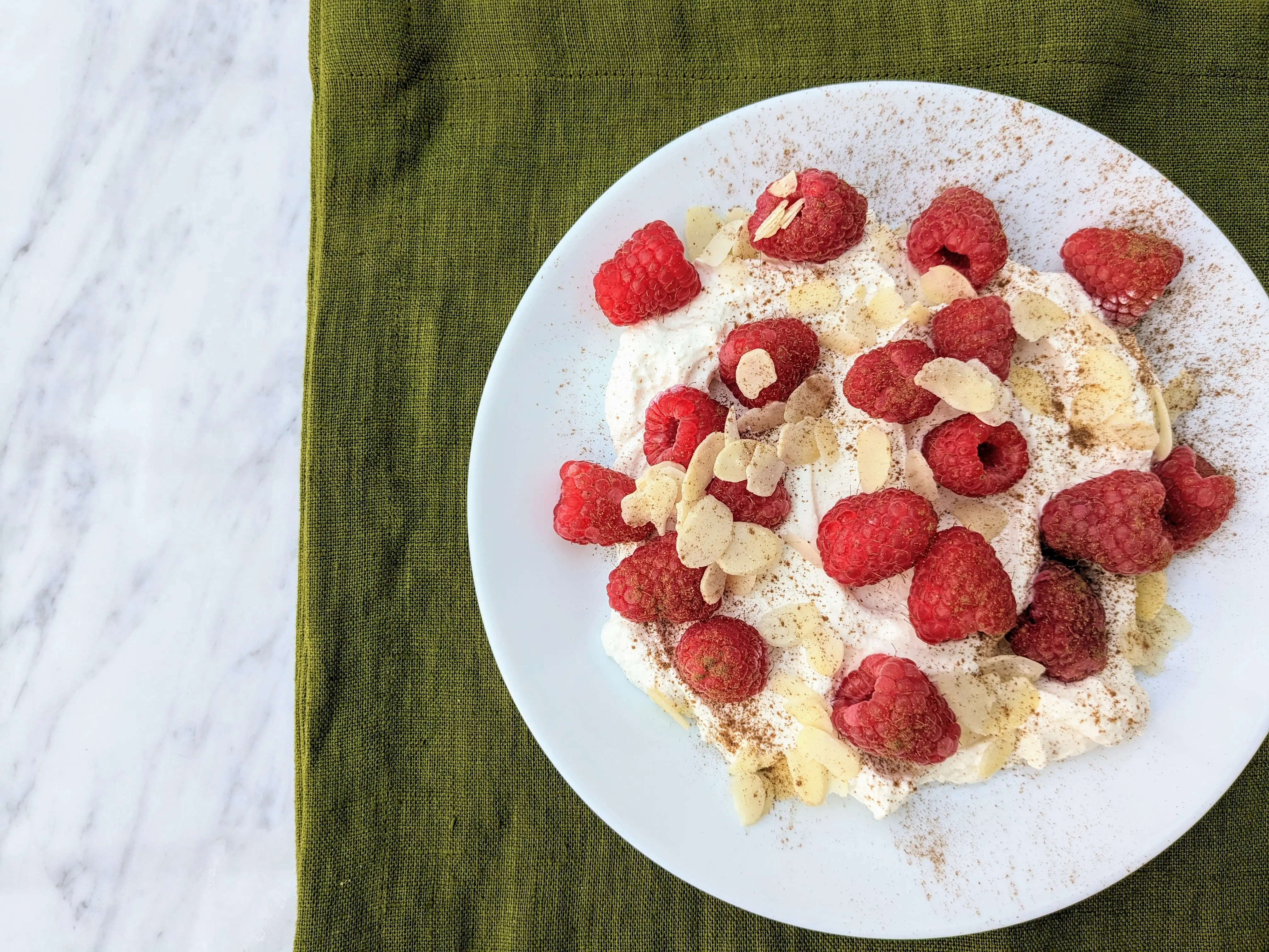 Ricotta with fresh raspberries and flaked almonds