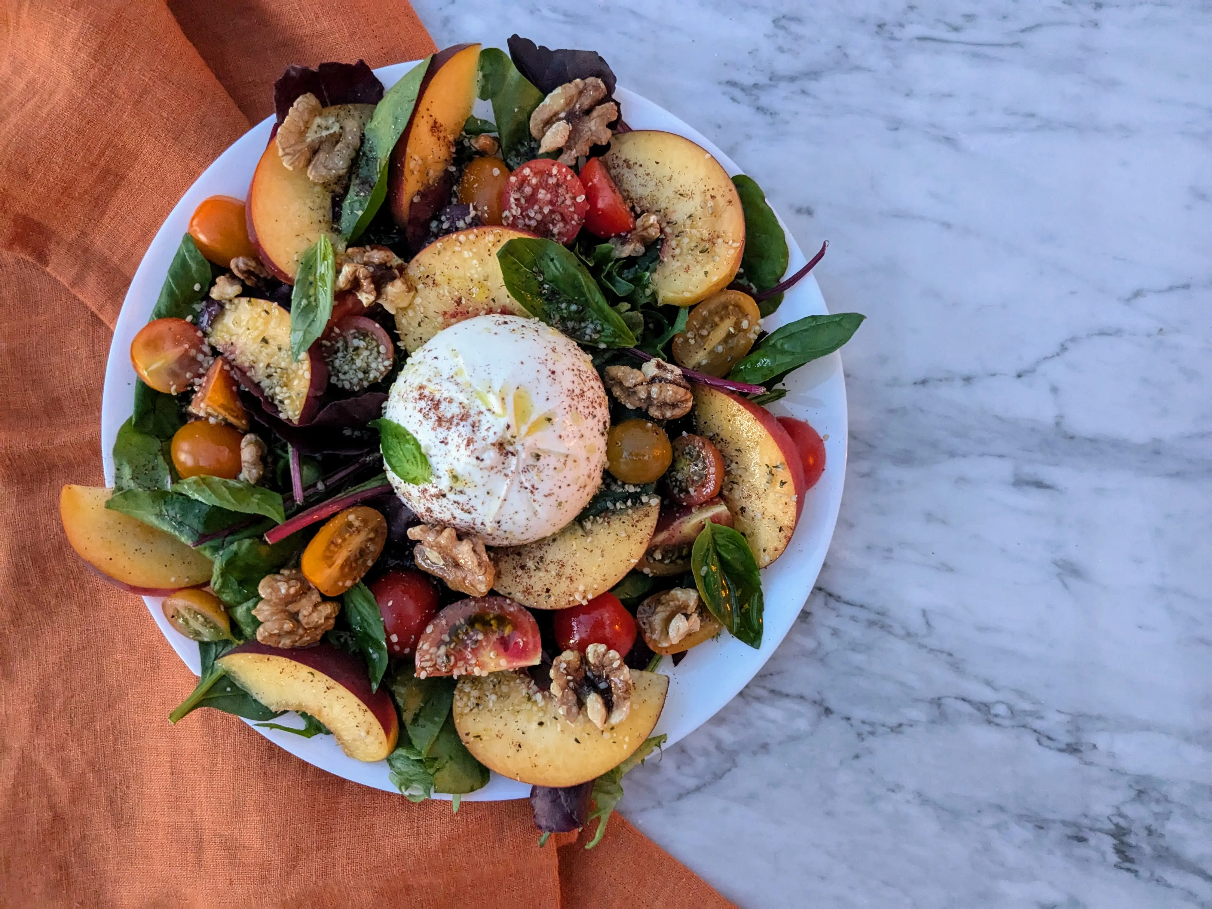 Summer salad with burrata, tomatoes and peach