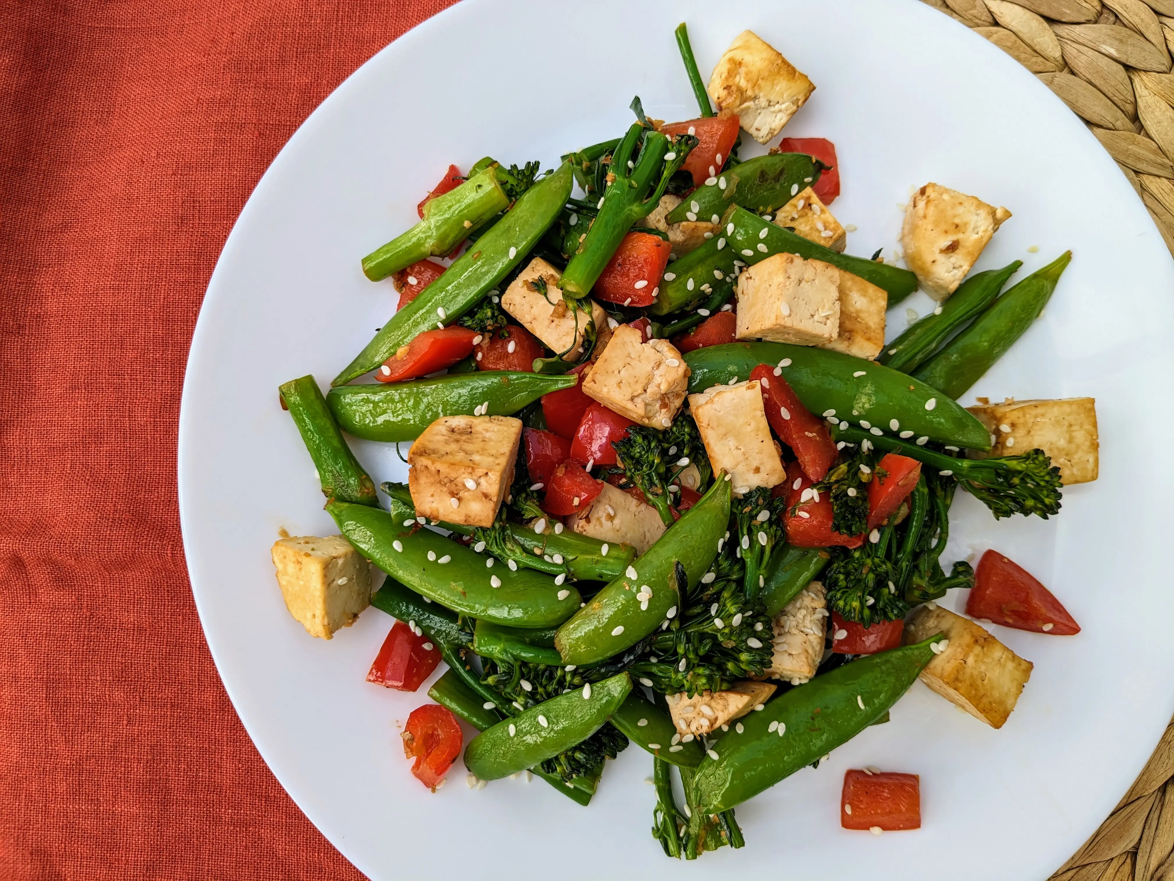 Vegan tofu stir-fried with broccoli, peppers, and snap peas
