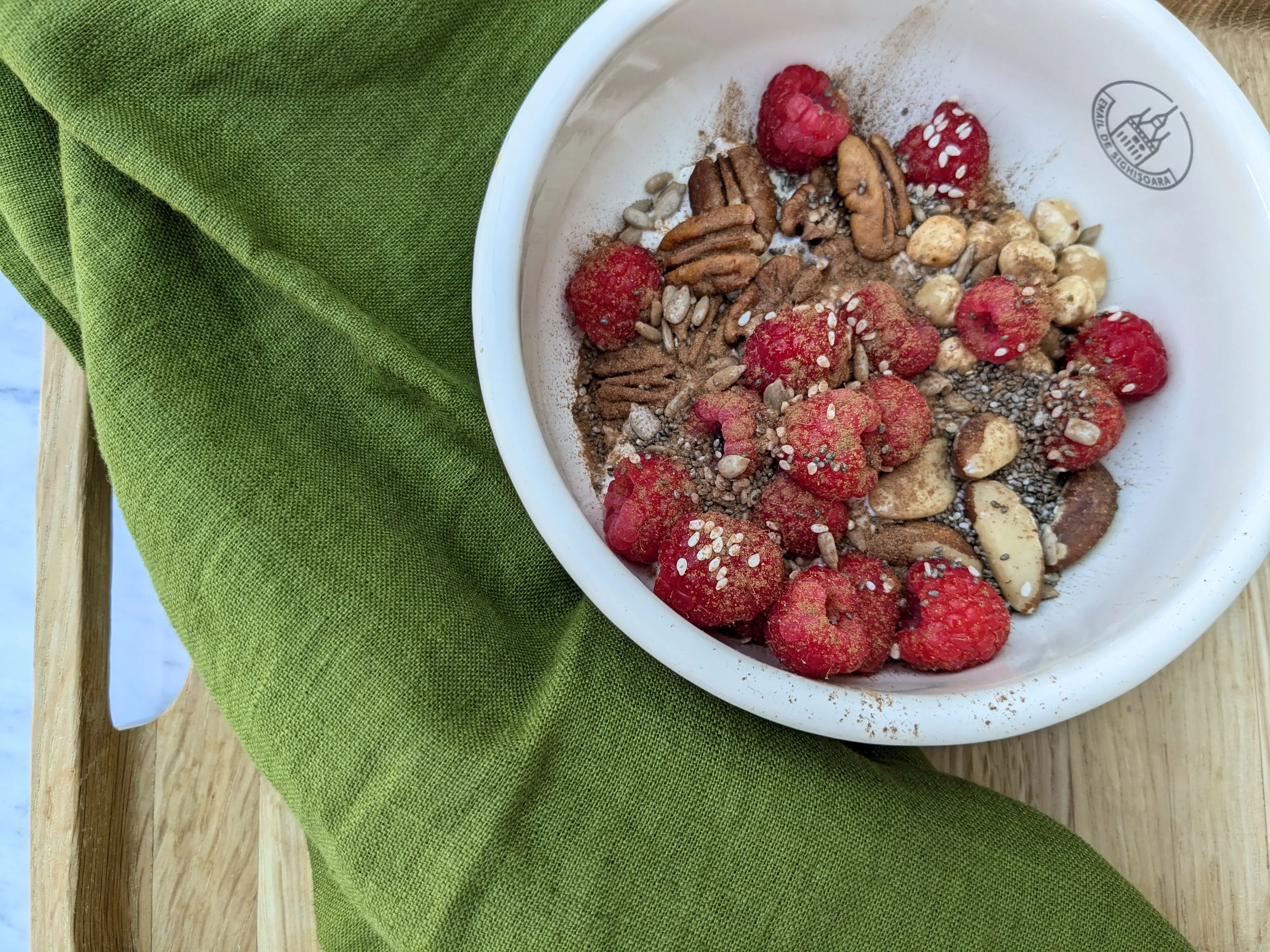 Yoghurt with mixed nuts, seeds and raspberries