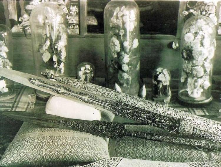 A magnificent depiction of the Preah Lumpeng Chey, the Royal Victory Spear of Cambodia, showcasing the Rahu carving and golden scabbard.