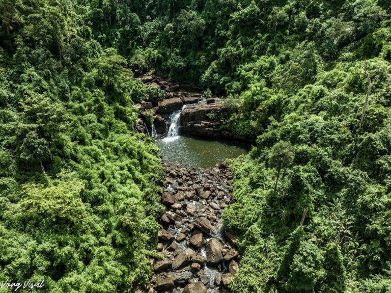 A hidden waterfall in the heart of the Cardamom Mountains with crystal clear water.