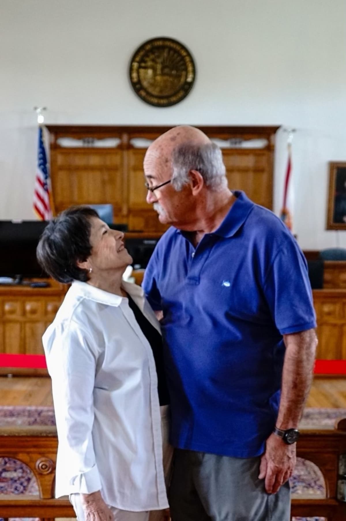 Couple making eye contact in a historic courtroom