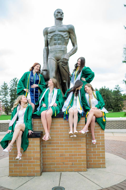 Graduate in a green gown