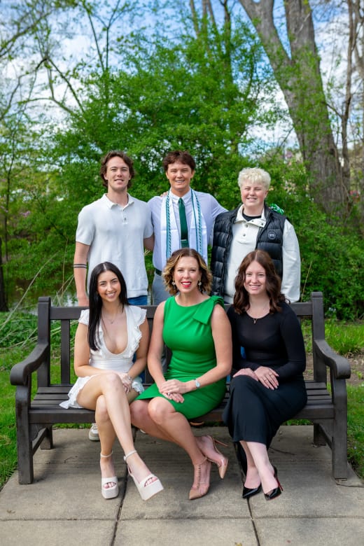 Family of six together on a bench
