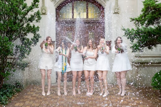 College graduation group popping champagne near Indianapolis