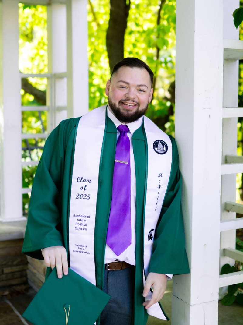 Male MSU graduate in cap and gown