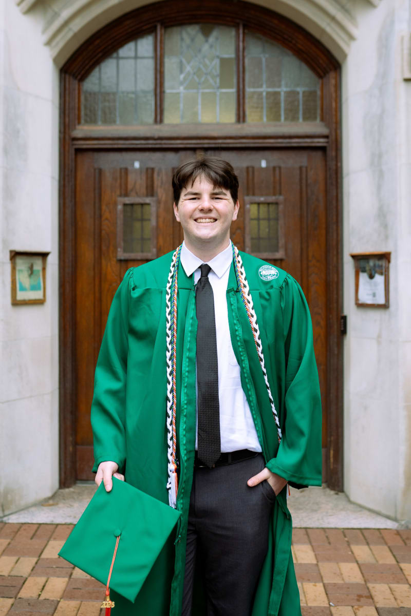 Male MSU graduate at a doorway