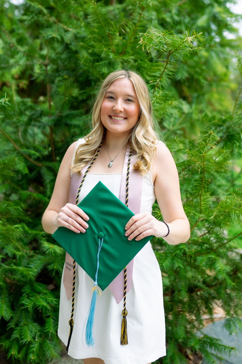 MSU graduate holding her cap