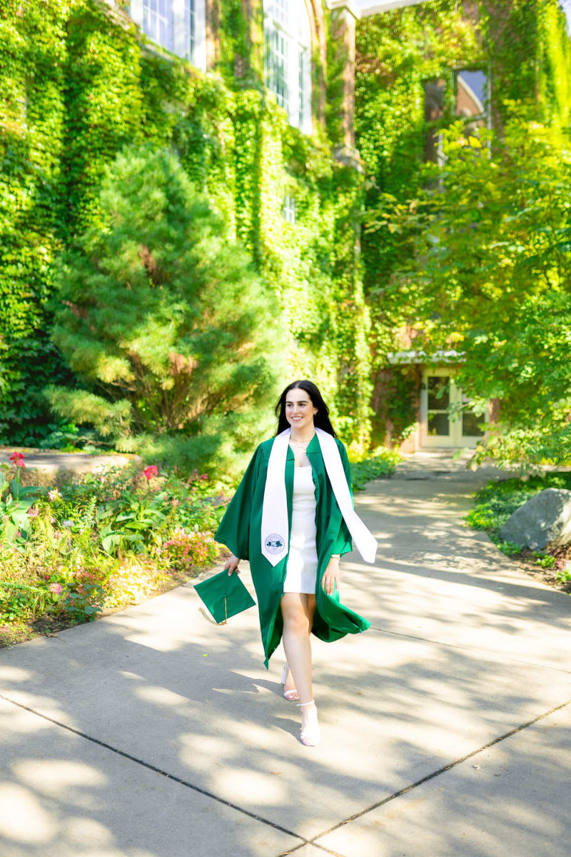MSU graduate walking across campus