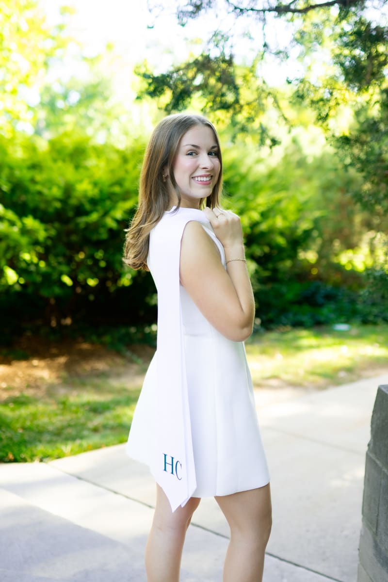 MSU graduate in a white dress on campus