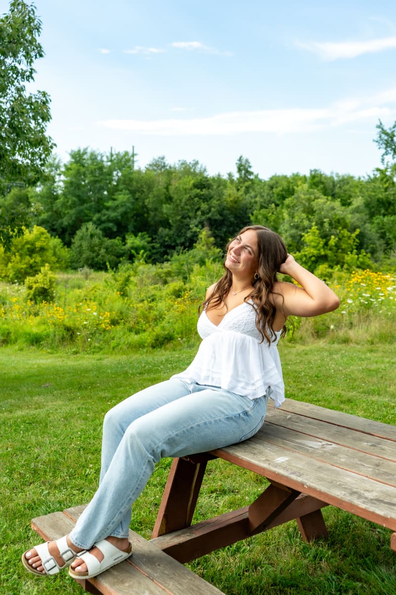 Indianapolis senior girl in jeans on a picnic table