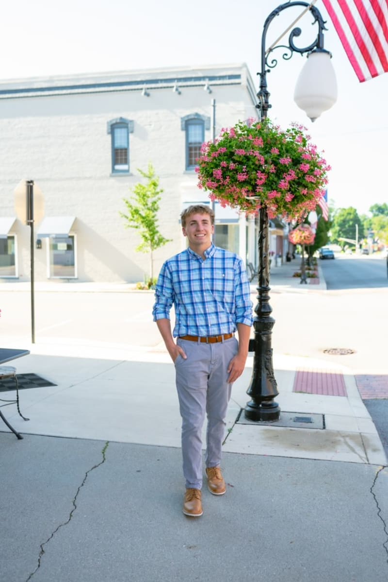 Indianapolis senior guy downtown by a lamppost