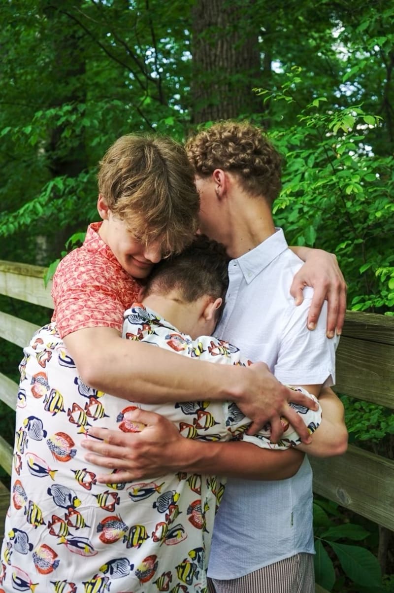 Three brothers laughing together