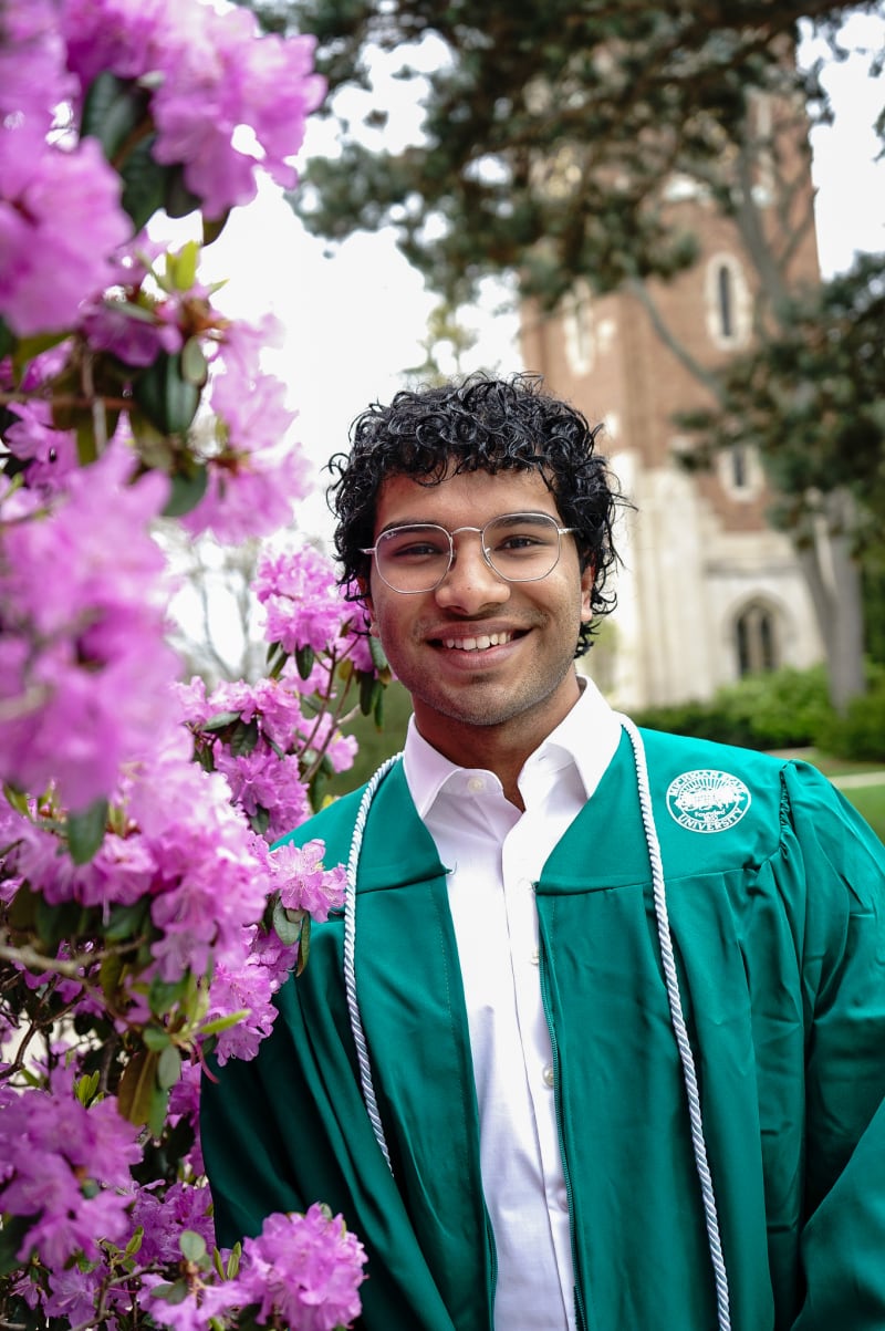 Male MSU graduate among spring blossoms