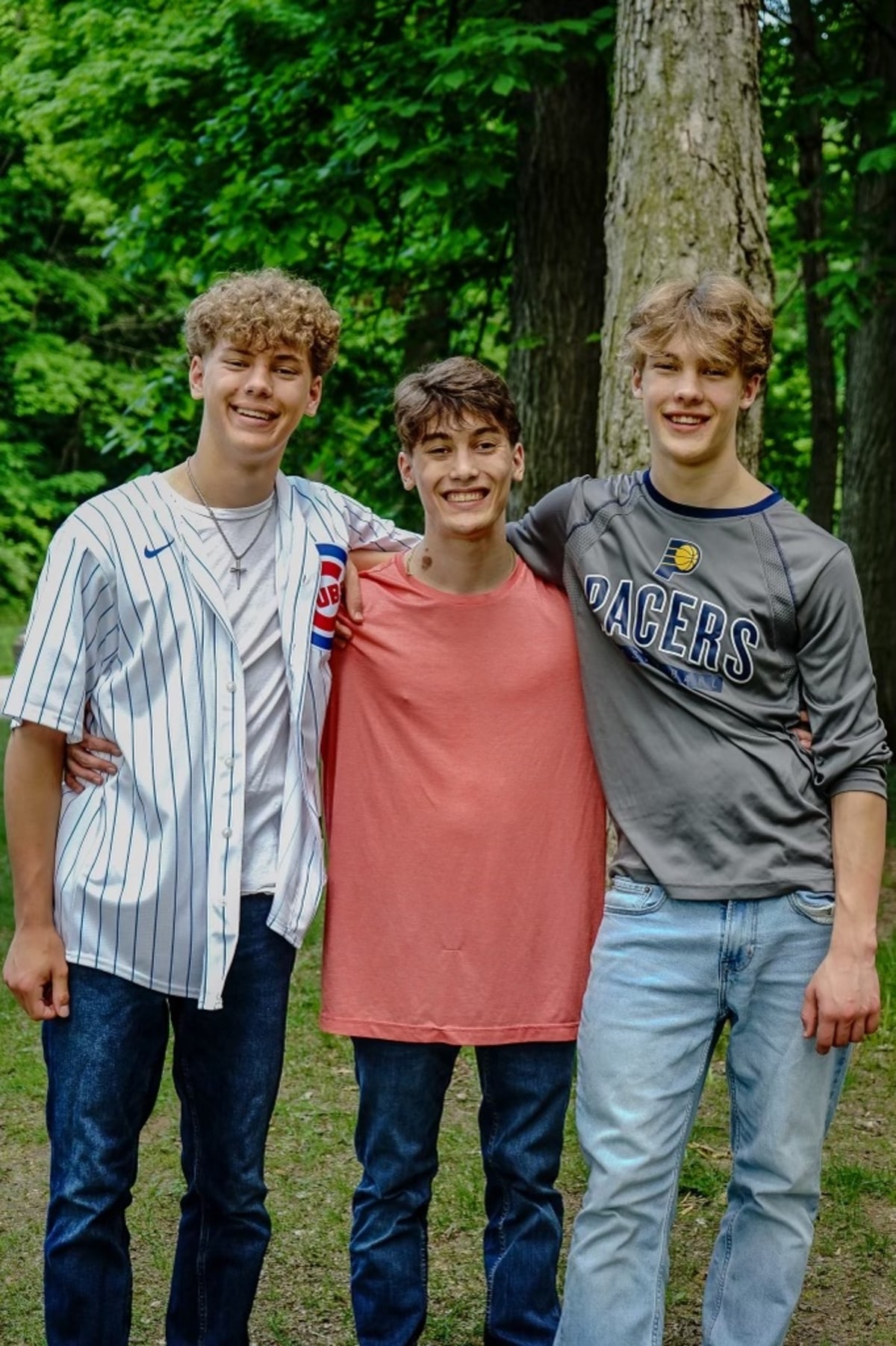 Three brothers standing together outdoors