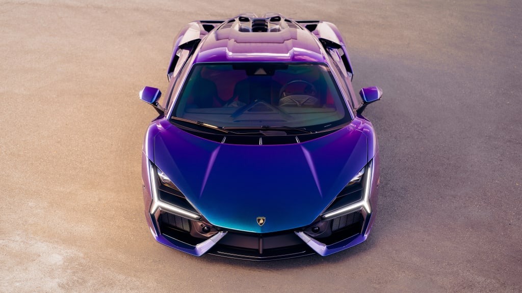 Aerial view of a sleek purple sports car with gradient blue accents, illuminated headlights, and open roof design on neutral