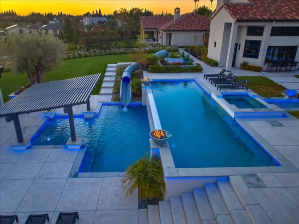 Chelshire Estates – sunset view with pool, slide, and pergola