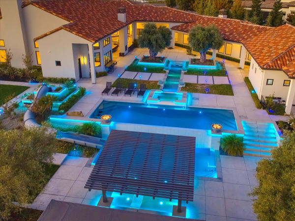 Chelshire Estates – aerial dusk with pool courtyard and home