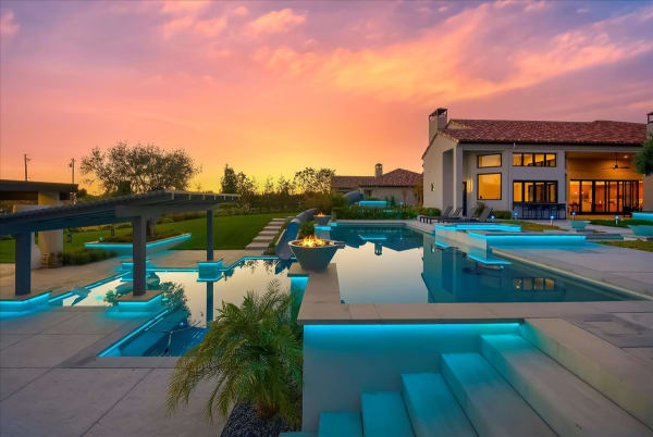 Chelshire Estates – ground-level sunset with fire bowl and pool
