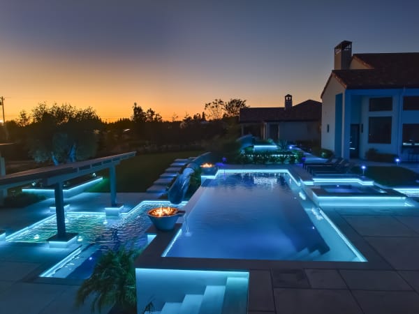 Call Residence – twilight pool complex with blue LEDs and sunset