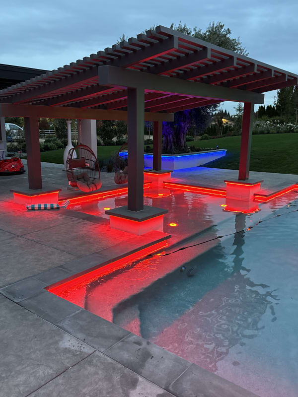 Call Residence – pergola with red LED lighting at dusk