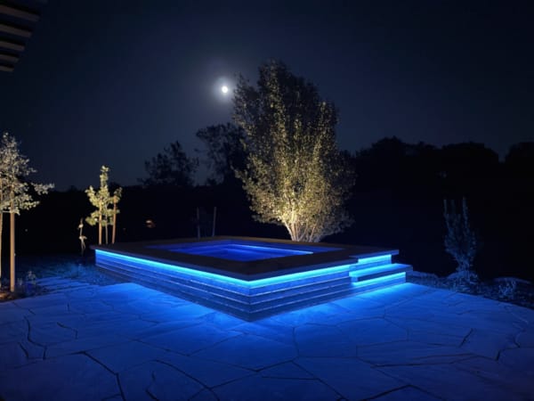 Wright – elevated spa with blue LED lighting under moonlight