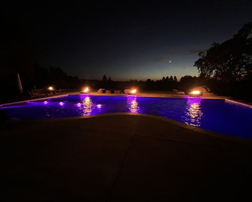 Pool with fire bowls and color lighting