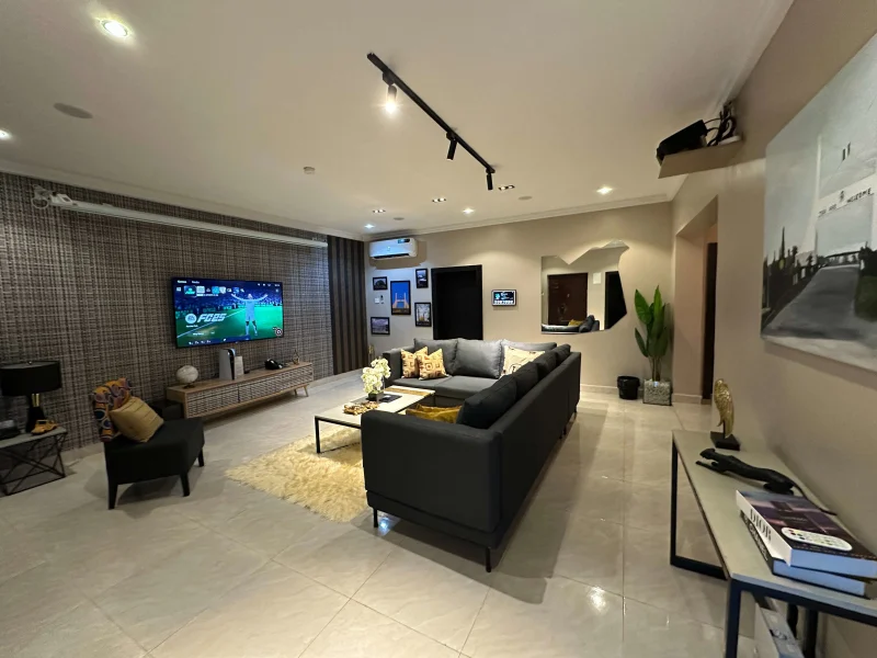 2 Bedroom Deluxe Suite at Aurora Smart Residence Abuja - spacious living room with modern furniture