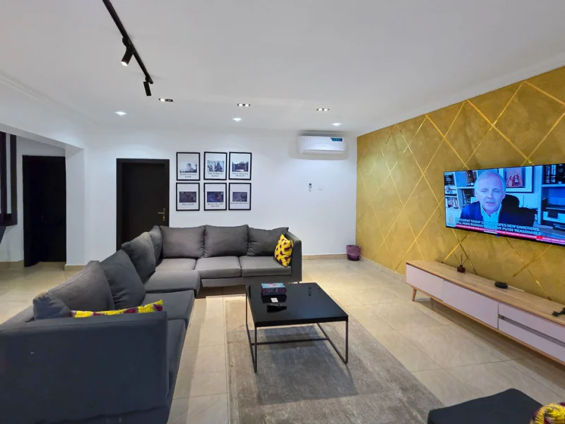 Kano Luxury Suite at Aurora Smart Residence Abuja - spacious living room with modern furniture