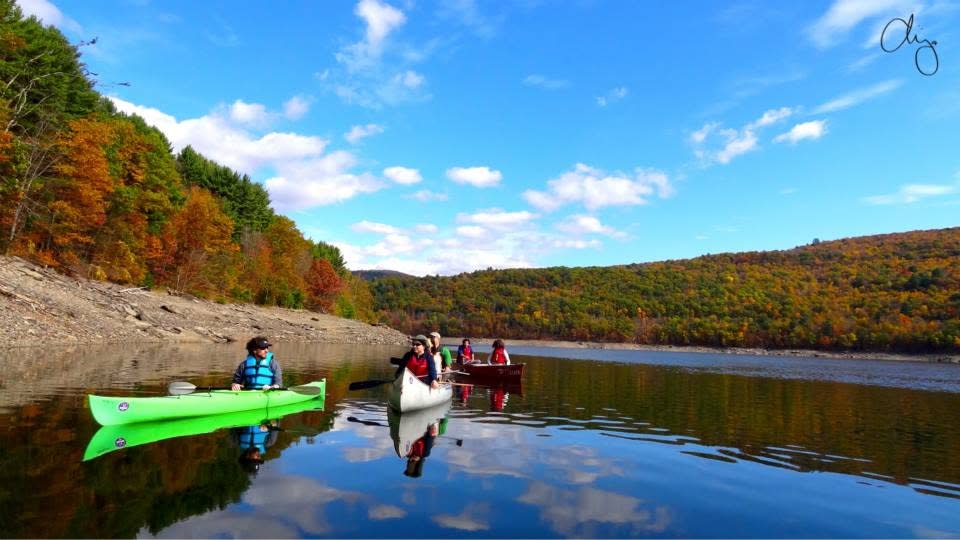 Canoe paddling surrounded by fall foliage in the Great Northern Catskils. Credit Destination Backcountry Adventures.