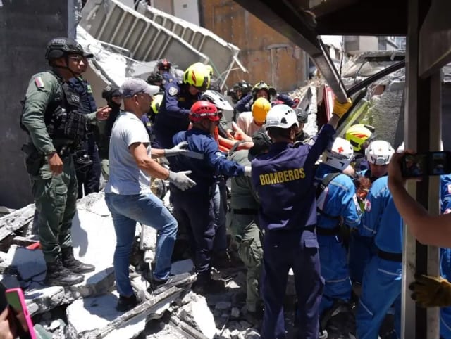 Rescuers search collapsed buildings after a 7.4 magnitude earthquake in Colombia