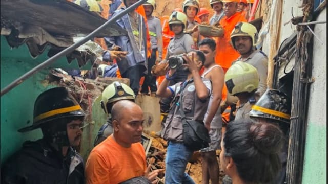 Rescue teams search through debris after a landslide at Gaushiya Chawl in Kurla, Mumbai.