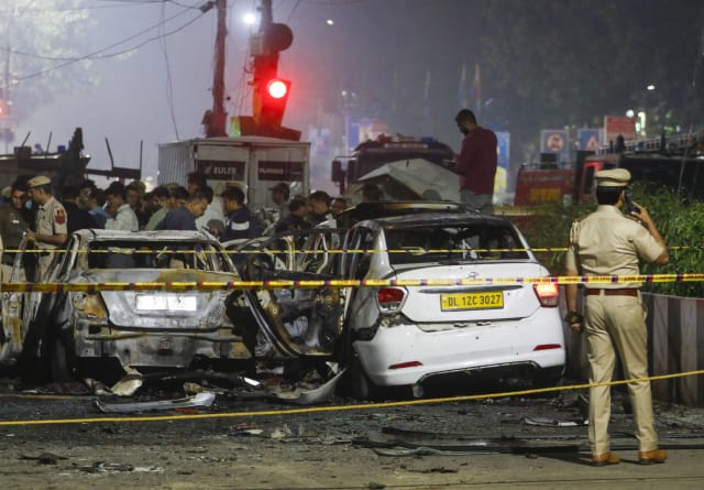 Security personnel investigate the site of the 2025 Red Fort blast in New Delhi