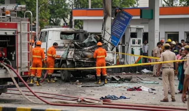 Fire personnel and police cordon off a CNG station after a truck cylinder explosion in Tikri Kalan, Delhi.