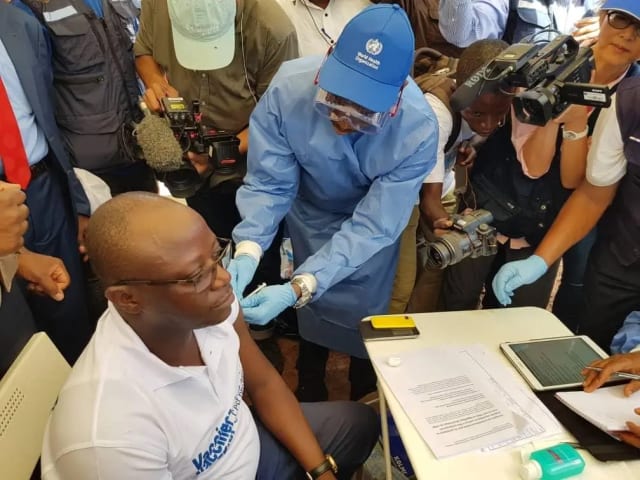 WHO health worker administers Ebola vaccine during an outbreak response in DR Congo.