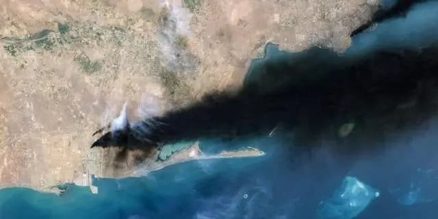 Satellite image showing thick black smoke rising from a Saudi energy facility after Houthi attacks.