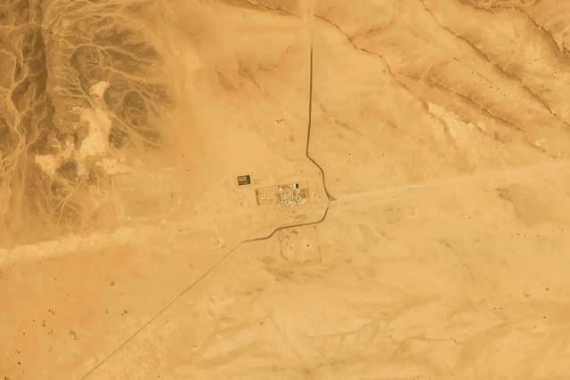 Satellite image showing damage and smoke near Saudi Arabia's East-West oil pipeline facility.