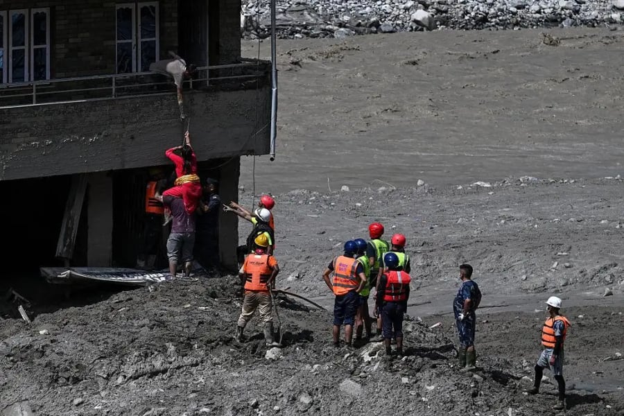 Rescue workers search through flood debris in Nepal's Nuwakot district after devastating flash floods.