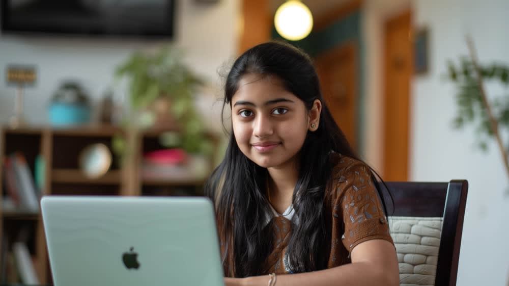 smiling-indian-girl-modern-home-setting-focused-her-laptop-screen-online-education