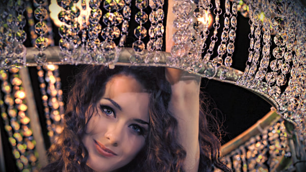 Aerial Chandelier Show Act Woman standing under a chandelier