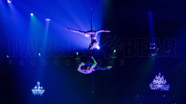 Flying Pole Duo -Two Artists, male and female performing in the air. Female artist performs upside down