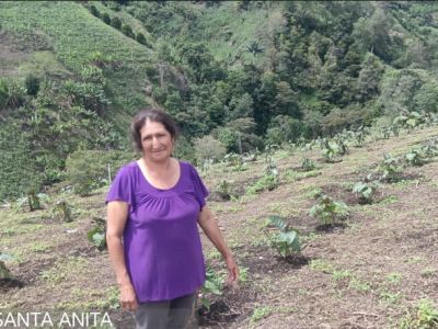 Rosa's hard work on her farm generates local employment and improves her household income.