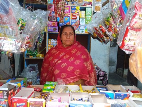 Asmat Sarfraz grew her home grocery shop by purchasing new stock.