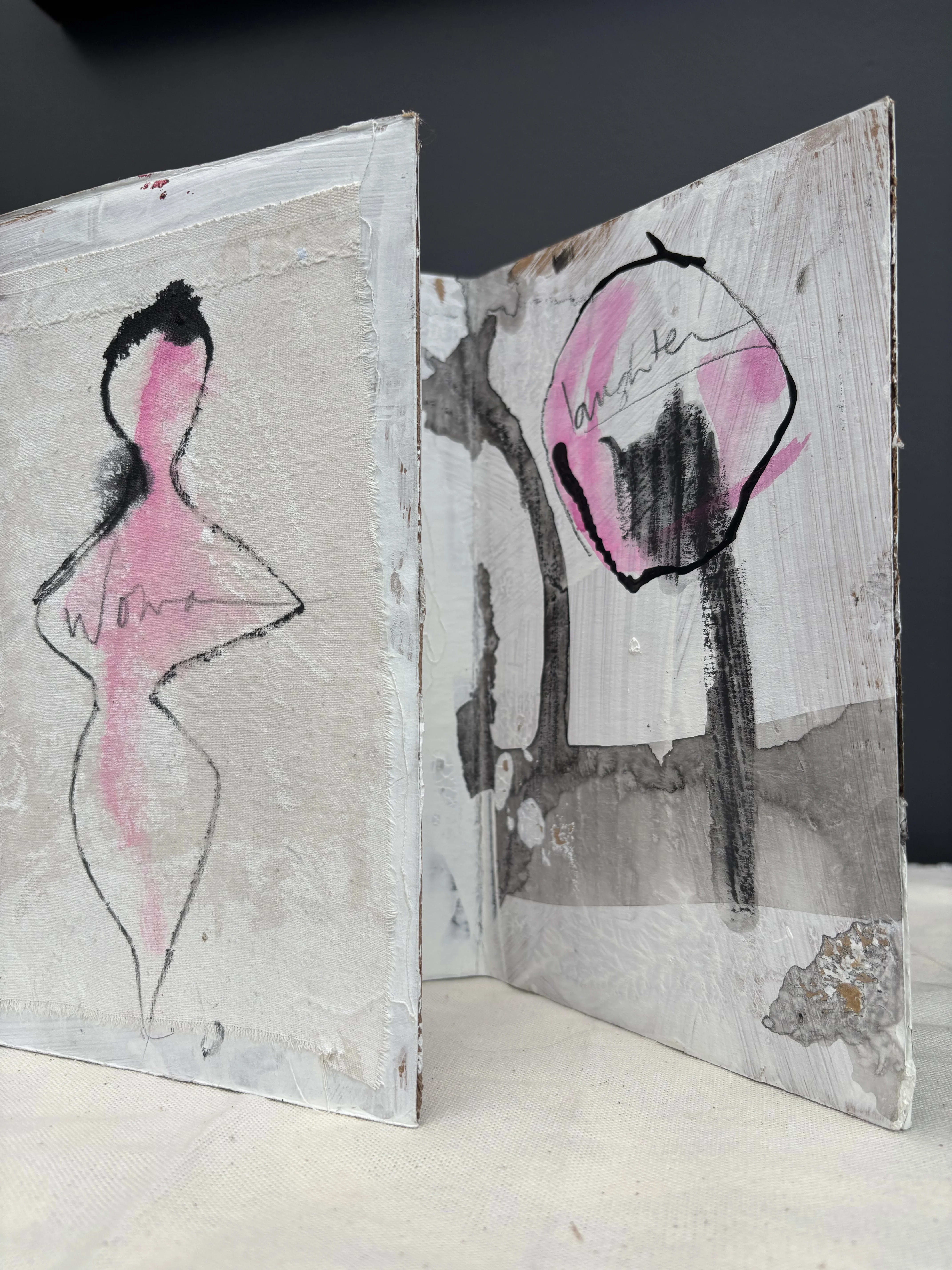 marks on cloth mounted on trifold cardboard