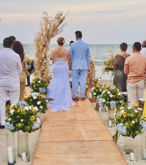 Walking down the beach aisle - real wedding held at Villa Lotus Tolú, Colombia