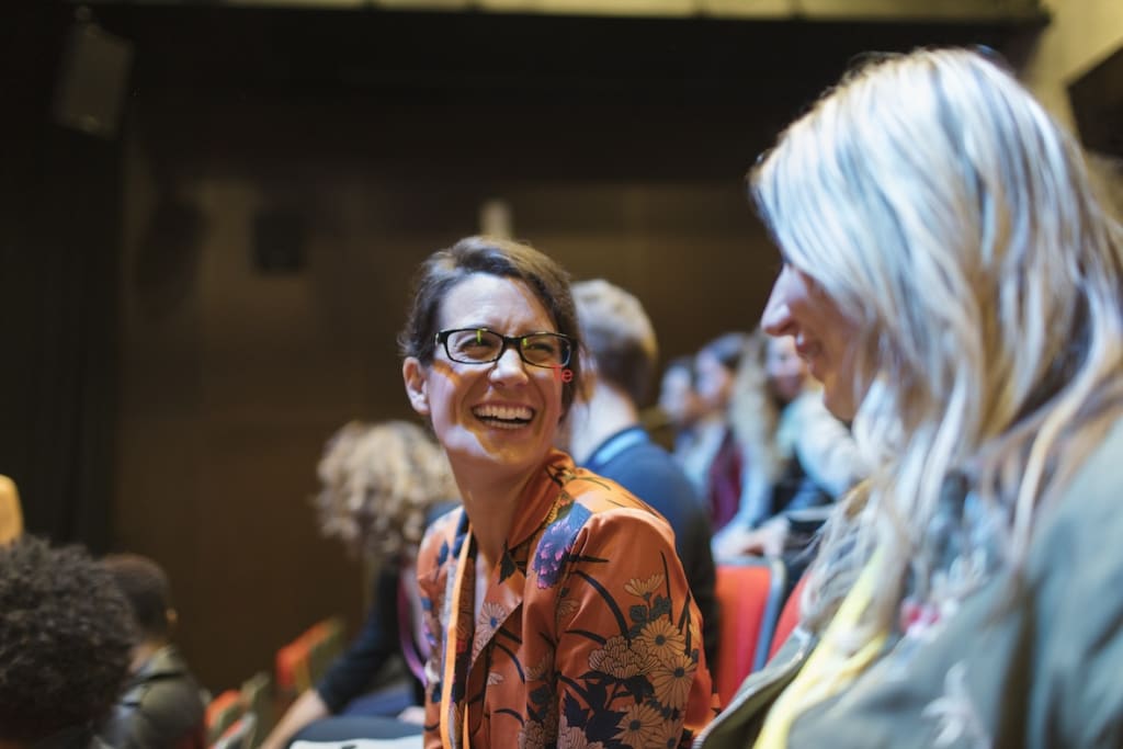 Woman laughing in the audience at event