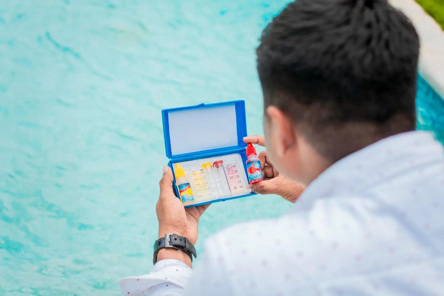 Man testing water at a pool